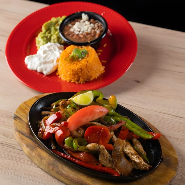 Habaneros Mexican Grill & Cantina's sizzling chicken fajitas with rice, beans, guacamole, and sour cream.