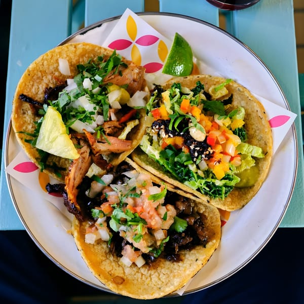 Three colorful Habaneros Mexican Grill & Cantina tacos with various toppings on a white plate.